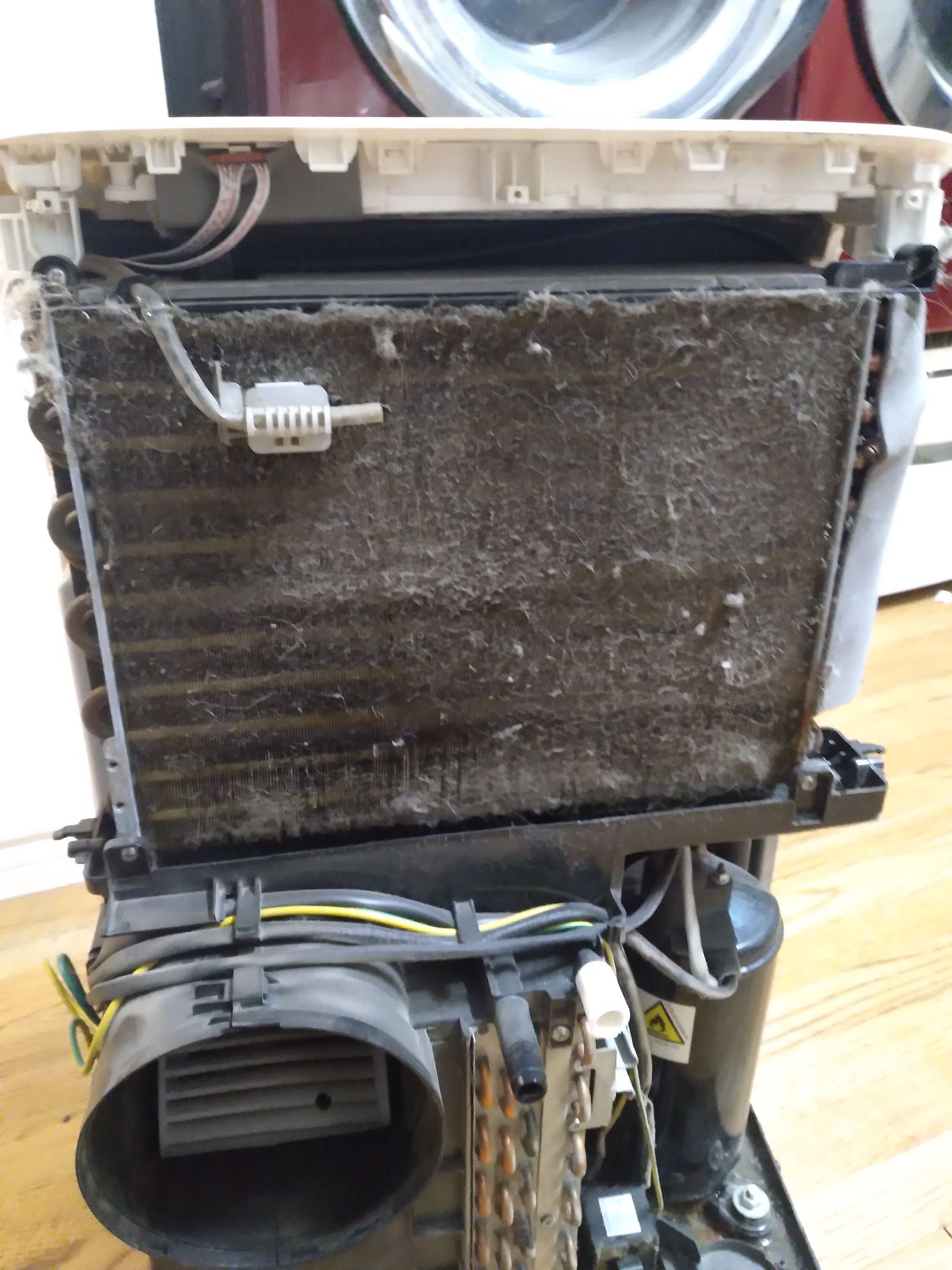 A dust-clogged air conditioner filter screen